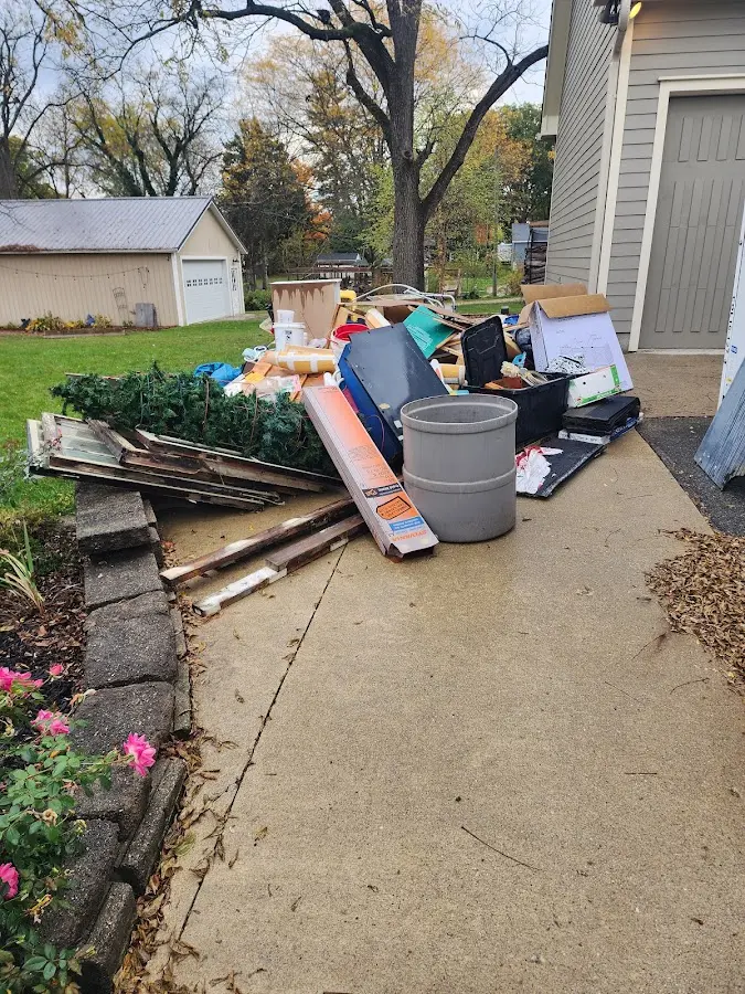 Dumpster being loaded with debris for Estate Cleanout Dumpster Rental in Pryor Creek